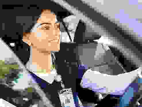 a healthcare worker driving a car